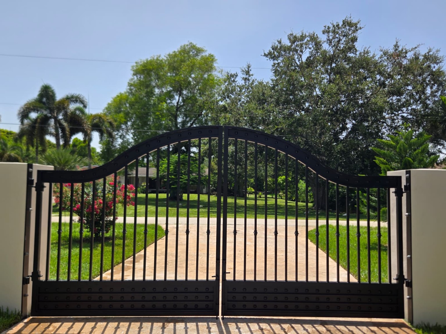 Black steel swing driveway gate installation