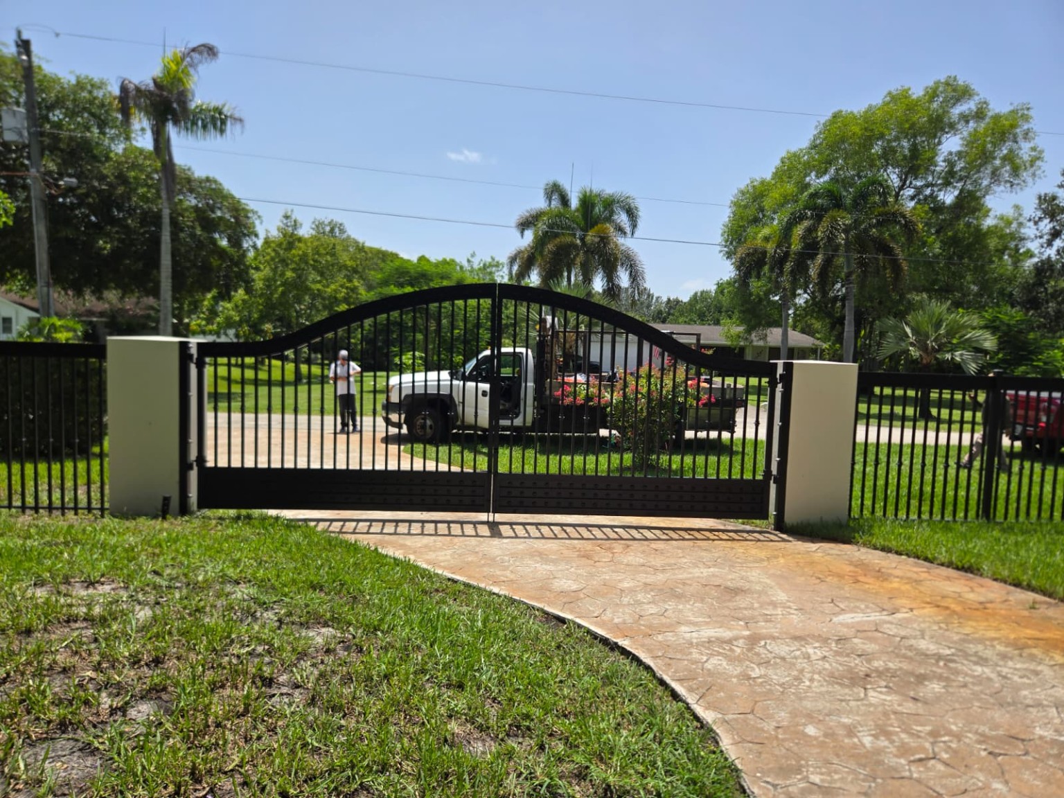 Black arched automatic driveway gate installation Fort Lauderdale