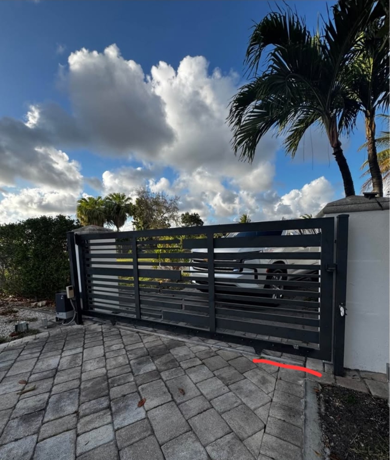Modern automatic sliding driveway gate installation in South Florida
